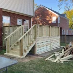 A wooden deck featuring stairs, surrounded by greenery, inviting for relaxation and outdoor gatherings.