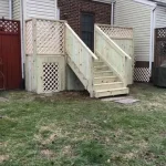 A wooden deck featuring stairs, surrounded by greenery, inviting for relaxation and outdoor gatherings.