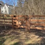 A farm wooden fence constructed from vertical planks, showcasing a natural wood finish and sturdy design.