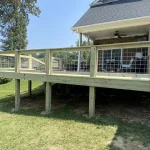 A wooden deck featuring stairs, surrounded by greenery, inviting for relaxation and outdoor gatherings.